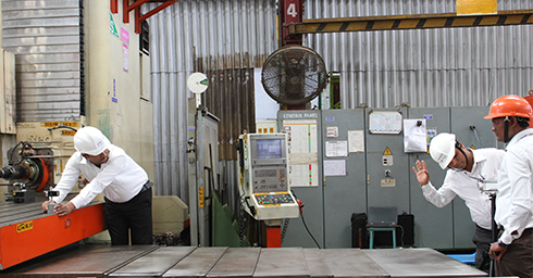 Godrej personnel calibrating a CNC machine with an XL-80 laser